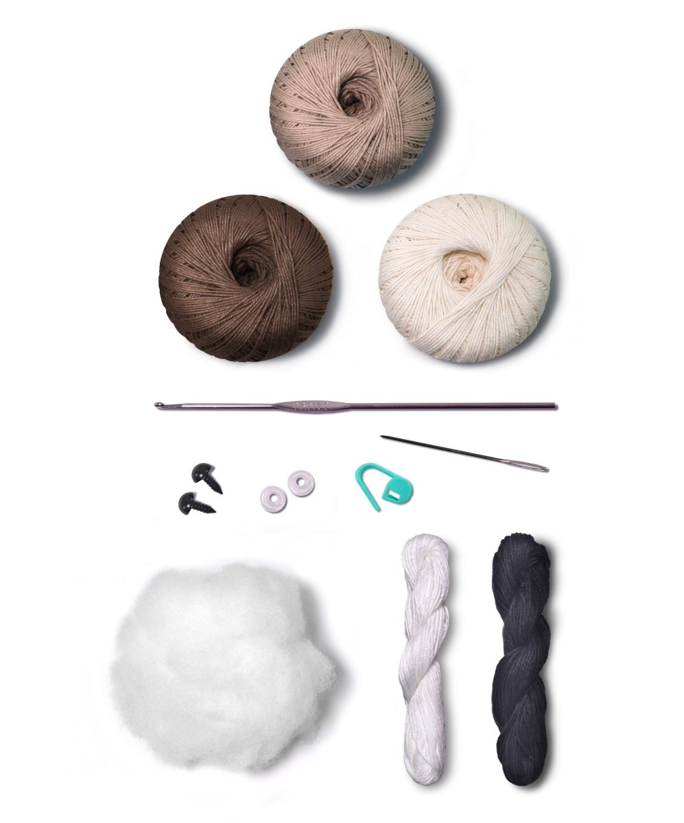 Hand holding finished Dog amigurumi.